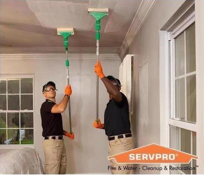 Servpro production techs removing soot