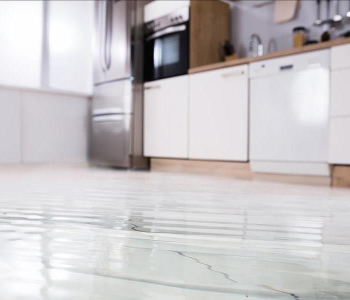 A kitchen with a few inches of water on the floor